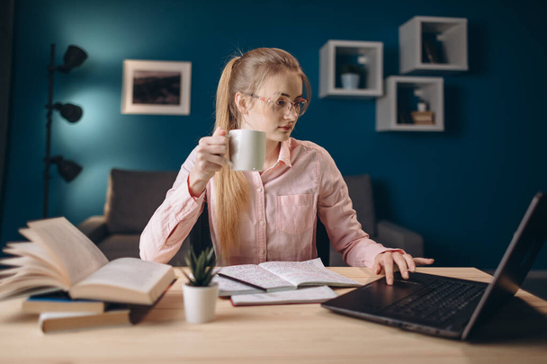 Young Female Ginger Student Having Coffee Using Laptop - Photo, Image