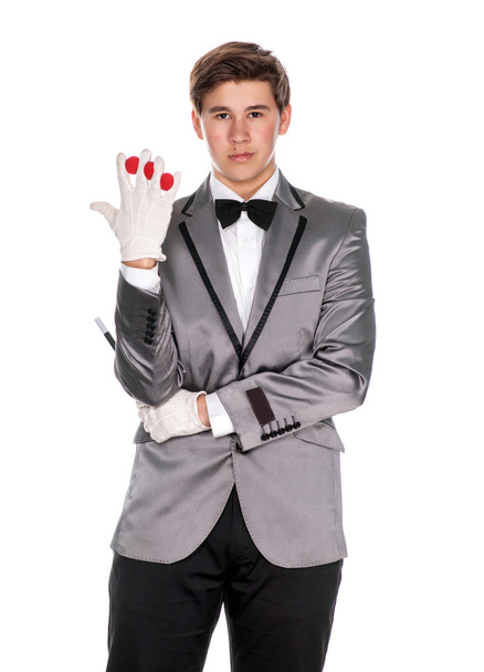 A magician holding a magic wand and balls - Foto, Bild