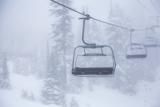 Chairlift on the Ski Resort during a foggy day - Φωτογραφία, εικόνα