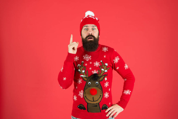 Consequence. Be careful. Warning concept. New year concept. Join winter holiday party. Christmas Party. Winter outfit. Hipster emotional bearded man wear winter sweater and hat red background - Foto, imagen