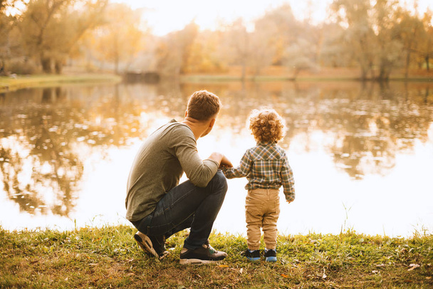 Photo of father and son having time together in park during autu - Photo, Image