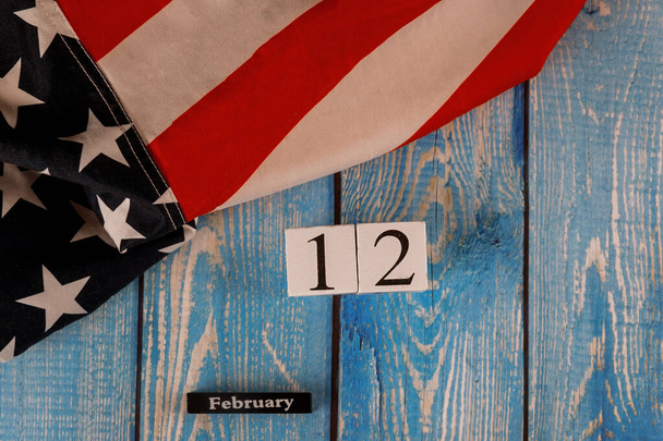 12 February calendar beautifully waving star and striped American flag on old wooden board. - Photo, Image