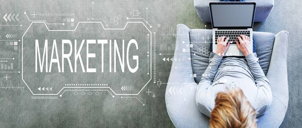 Marketing concept with man using a laptop - Photo, Image