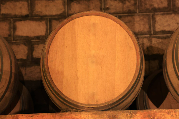 Wine barrels stacked in the cellar  - Photo, Image