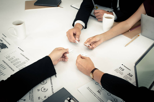 Closeup of businesspeople holding jigsaw puzzle. - Photo, Image