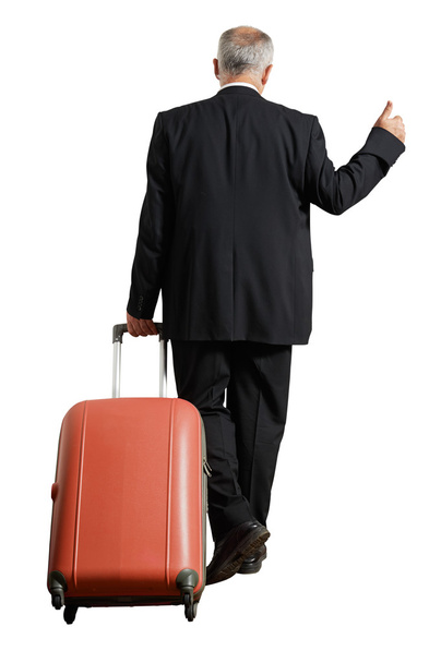 бізнесмен з валізою йде пішки
 - Фото, зображення