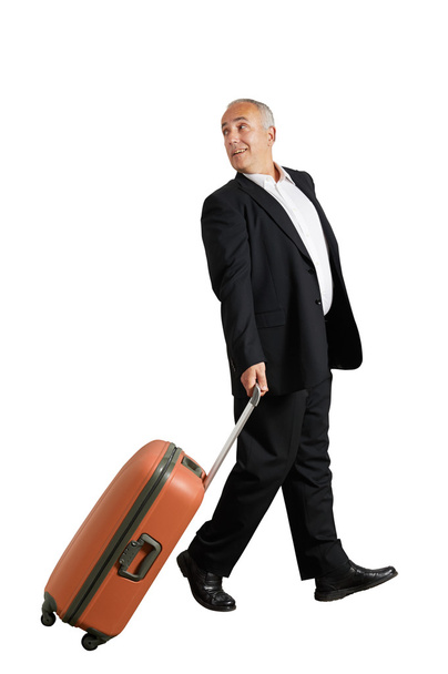 man with suitcase looking back and smiling - Фото, изображение