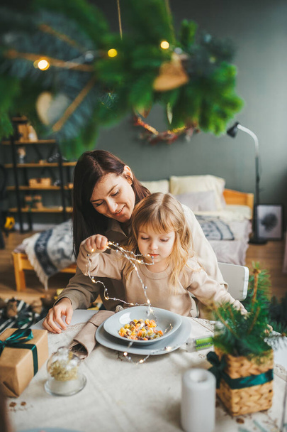 Mother and daughter eat tasty food and having fun. - Photo, Image