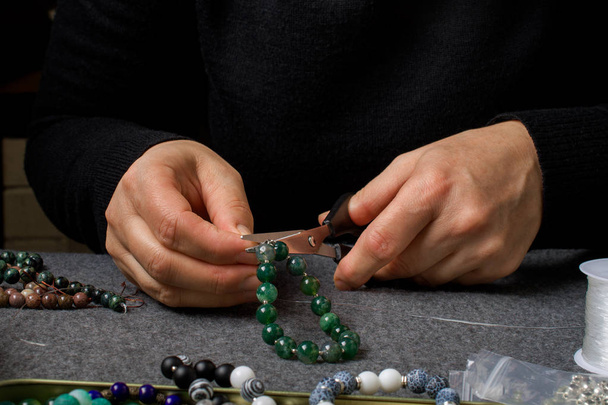 Woman making homemade beaded  bracelet, closeup. - Photo, Image
