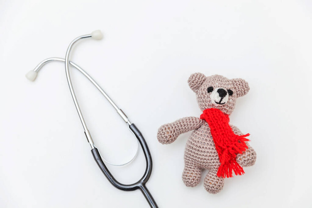 Simply minimal design toy bear and medicine equipment stethoscope isolated on white background. Health care children doctor concept. Pediatrician symbol. Flat lay, top view copy space - Foto, Imagem