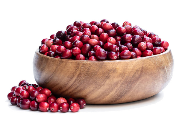 Fresh cranberries in wooden bowl isolated on white  - Fotó, kép