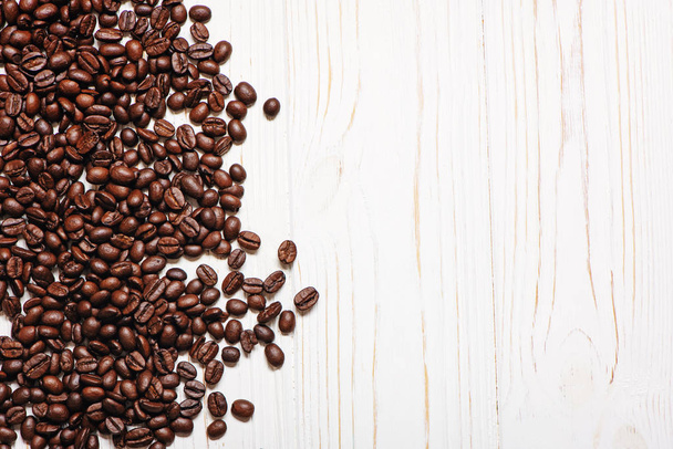 Roasted coffee beans on wooden background. - Photo, Image