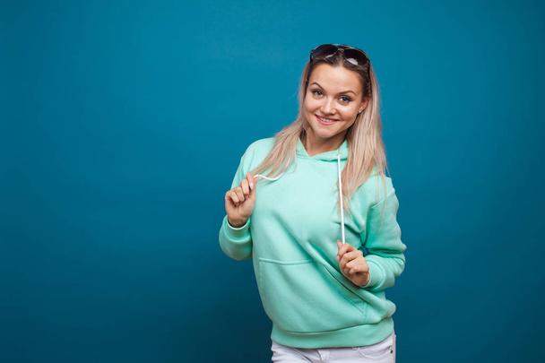 Fashionable young girl in blue hoodie. young woman - Valokuva, kuva