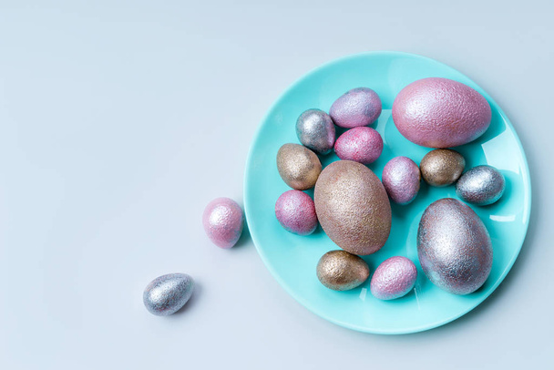 Colored chicken and quail eggs of pink, silver, golden and blue color  - Photo, Image