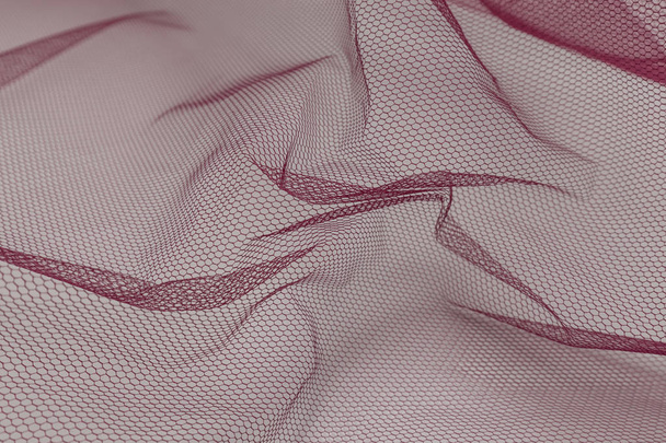 テキスタイルの背景を持つピンクのチュール生地の美しいクローズアップ - 写真・画像