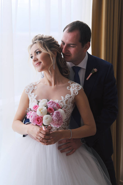 Closeup portrait of newlyweds posing in room - Photo, image