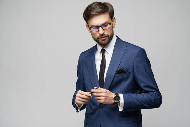 Studuo shot of thinking solving problem businessman wearing suit holding pen - Fotó, kép