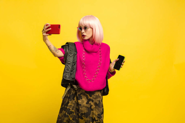 Caucasian womans portrait isolated on yellow studio background, influencer be like - 写真・画像
