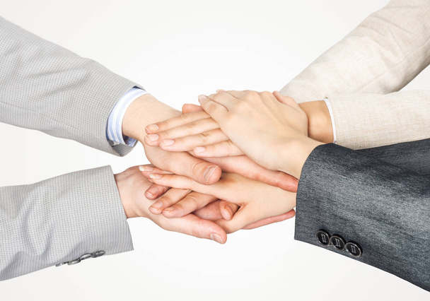 Close up of businesspeople putting their hands together against white background - Photo, Image