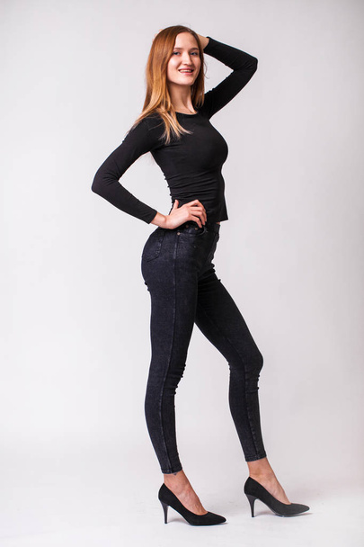 Beautiful sexy woman in black jeans - Photo, Image