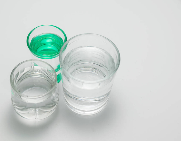 transparent glasses and one green glass with water - Foto, immagini
