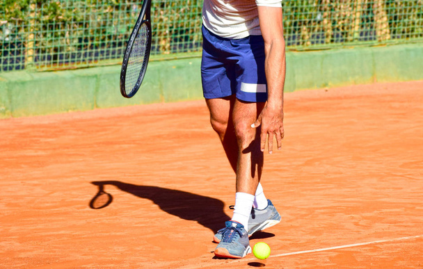 Κοντινή φωτογραφία του επαγγελματία τενίστα με ρακέτα και μπάλα του τένις. - Φωτογραφία, εικόνα