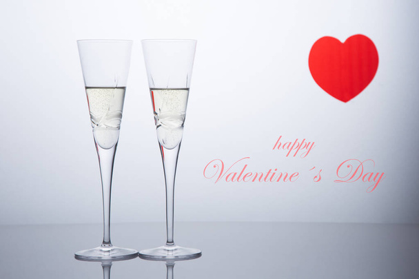 Valentines day composition  with two glasses of champagne and a red heart. San Valentine and Love concept. - Photo, Image