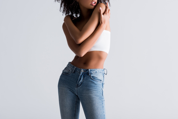 cropped view of african american woman in white top isolated on grey - Fotografie, Obrázek
