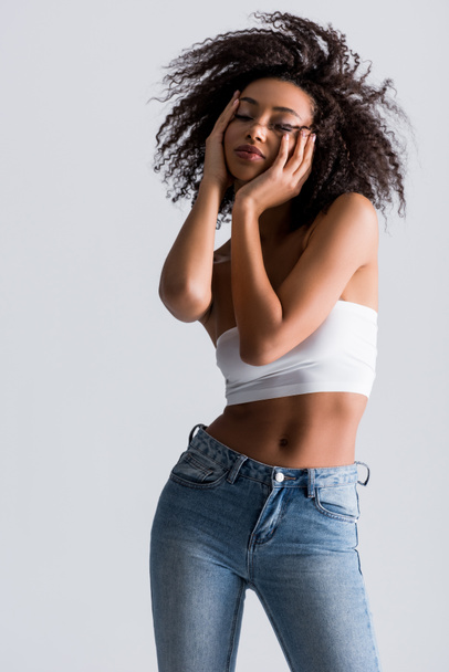 african american woman in white top with closed eyes isolated on grey - Fotó, kép