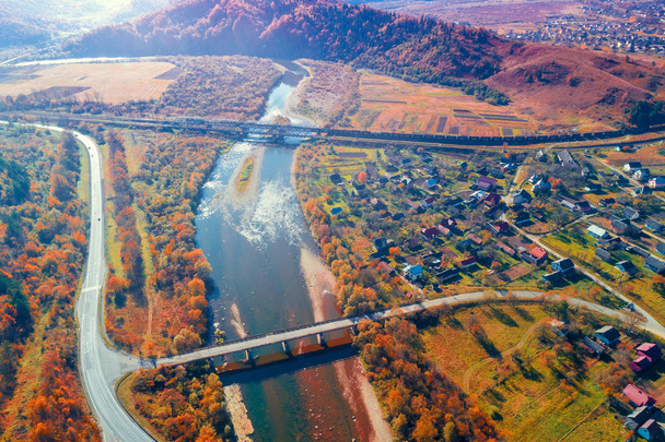 Panoramic view of a mountain valley with river, highway, and bridges in autumn. View from above - Photo, Image