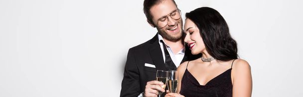 panoramic shot of beautiful happy couple with champagne glasses for valentines day on white - Foto, Imagen