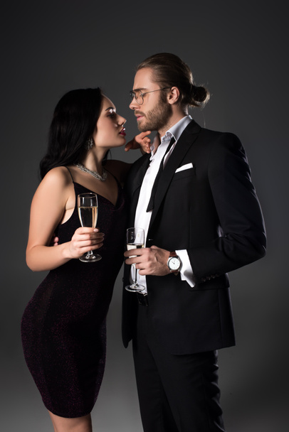 beautiful couple with champagne glasses for valentines day on grey - Foto, imagen