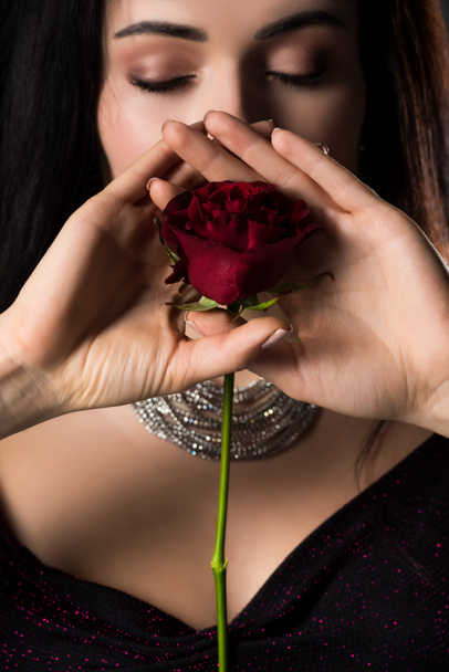 attractive young woman holding rose flower, isolated on grey - Fotoğraf, Görsel