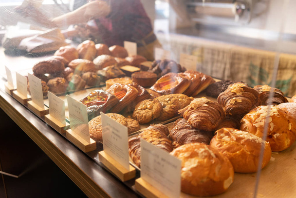 Pastry on display in a bakery: croissants, danish - Photo, Image