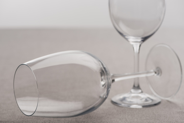 Selective focus of transparent wine glasses isolated on grey - Fotografie, Obrázek