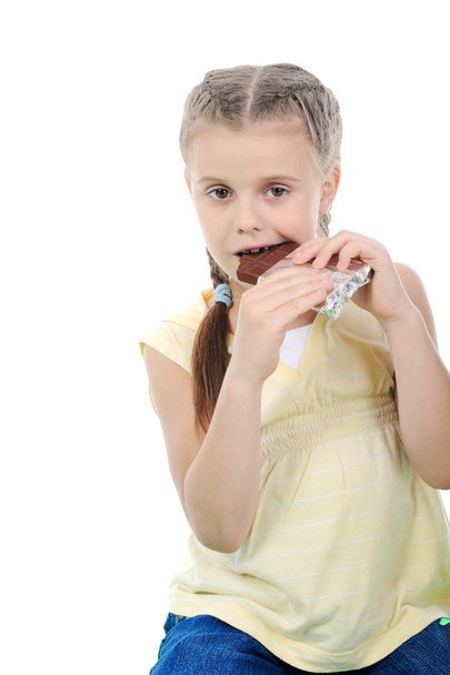 Little girl eating chocolate. - Foto, imagen