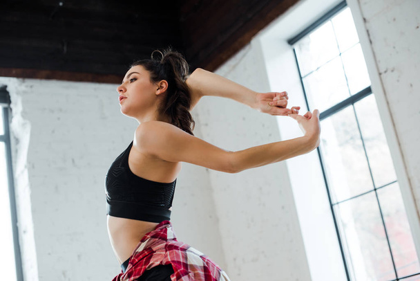 flexible young woman posing in dance studio  - Φωτογραφία, εικόνα
