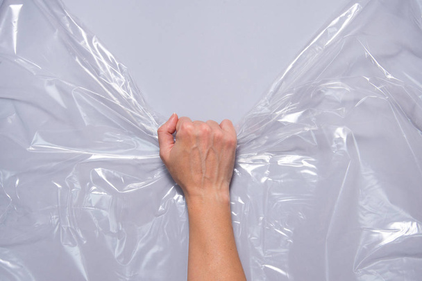Woman hands pull polyethylene film - Zdjęcie, obraz