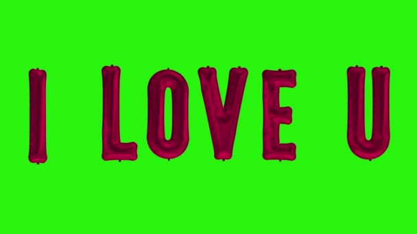 Helyum kırmızısı folyo balondan "Seni seviyorum" kelimeleri yeşil ekranda yüzüyor. - Video, Çekim