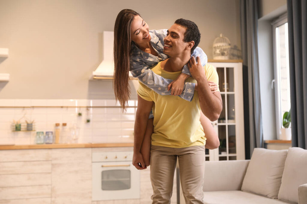 Lovely young interracial couple having fun at home - Φωτογραφία, εικόνα