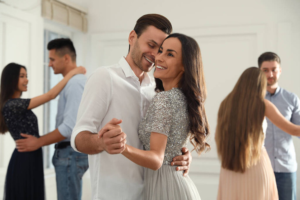 Lovely young couple dancing together at party - Фото, изображение