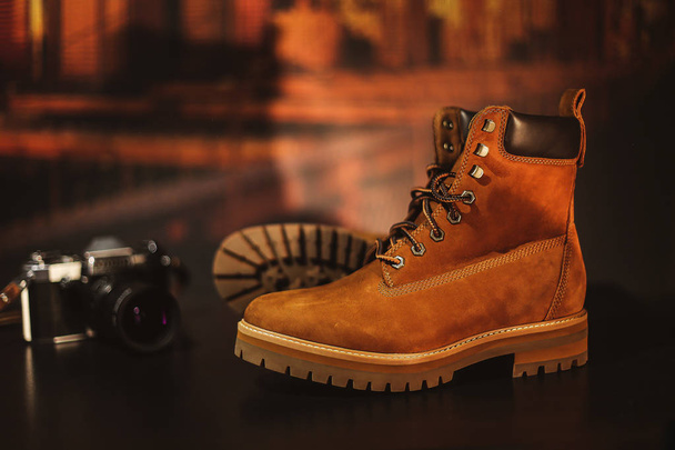 Zimowe skórzane brązowe buty na tle z kamerą vintage - Zdjęcie, obraz