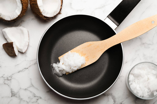 Flat lay composition with coconut oil and frying pan on white ma - Fotoğraf, Görsel