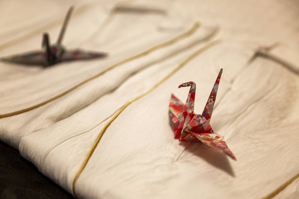 Kyoto, Japan, 04/07/2017: Origami in the form of a crane in hotel robes. Compliment staff to the client. Close-up. - Φωτογραφία, εικόνα