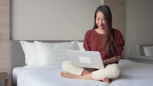 footage of Asian woman working with laptop at home - Imágenes, Vídeo