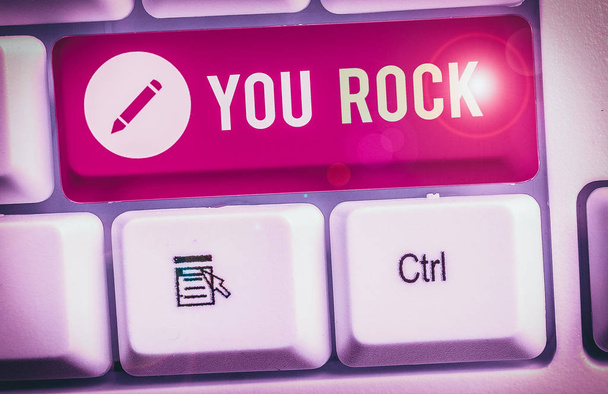 Text sign showing You Rock. Conceptual photo slang phrase of praise or encouragement conveying you are awesome. - Photo, Image