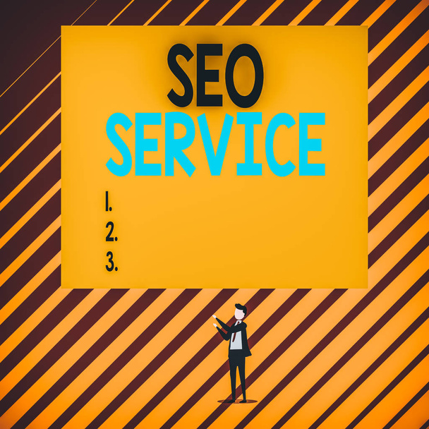 Text sign showing Seo Service. Conceptual photo techniques and procedures to increase the website visibility Short hair immature young man stand in front of rectangle big blank board. - Photo, image