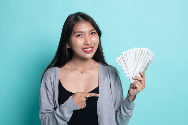 Portrait of  young asian woman  showing bunch of money banknotes - Фото, зображення