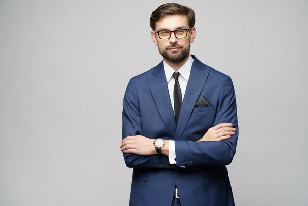 studio photo of young handsome stylish businessman wearing suit - Fotó, kép