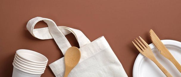 Zero waste concept. Reusable produce bag, bamboo cutlery, carton cups and plate. Plastic free sustainable lifestyle. Flat lay, top view. Eco store banner. - Photo, image